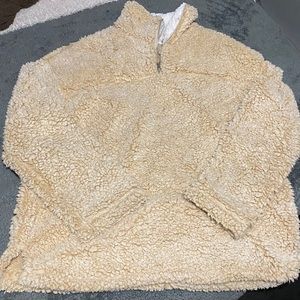 A beige sherpa pullover